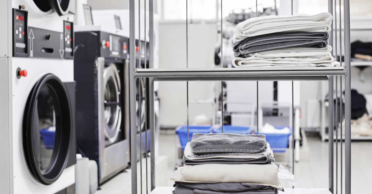 Clean items on the rack at the dry cleaners environmental sustainability examples
